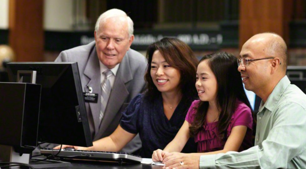ソルトレークにある家族歴史センターで系図を調べる家族を助けるシニア宣教師